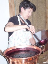 Jo pours the jams in the pots.